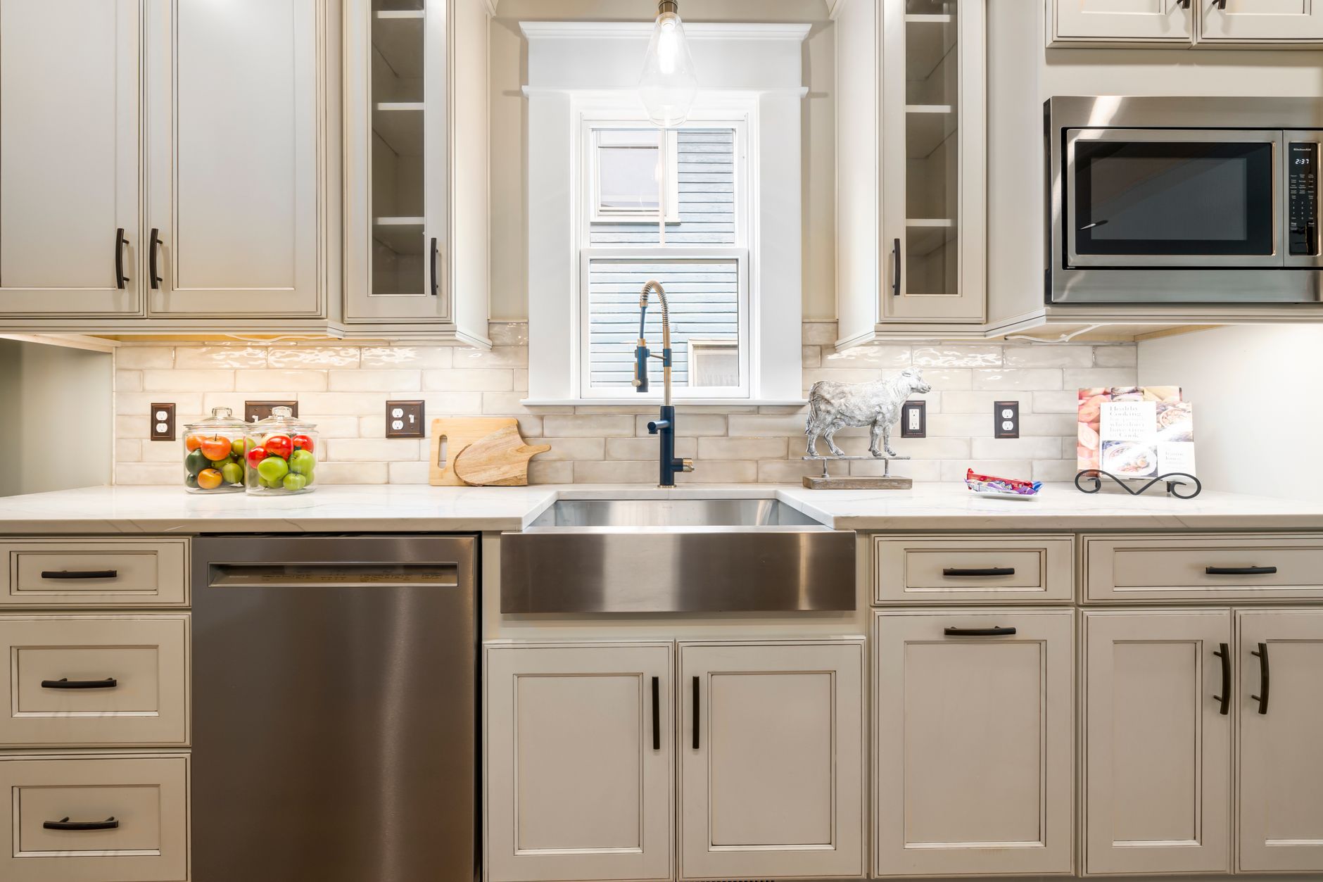 Contemporary kitchen featuring a stainless steel farmhouse sink and modern appliances in Bellevue, WA