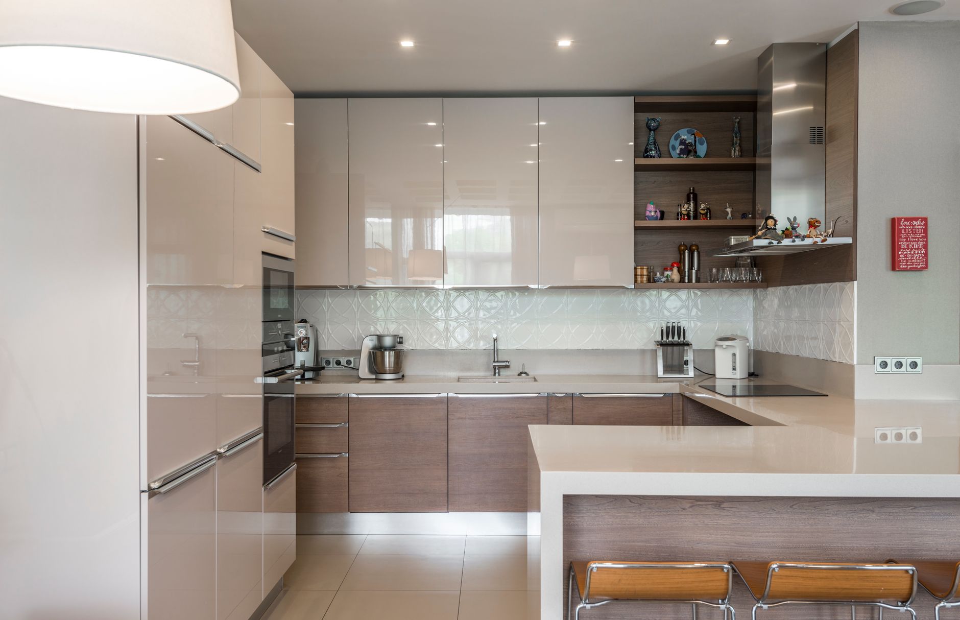 Sleek modern kitchen with white cabinets, island, and built-in appliances in Bellevue, WA