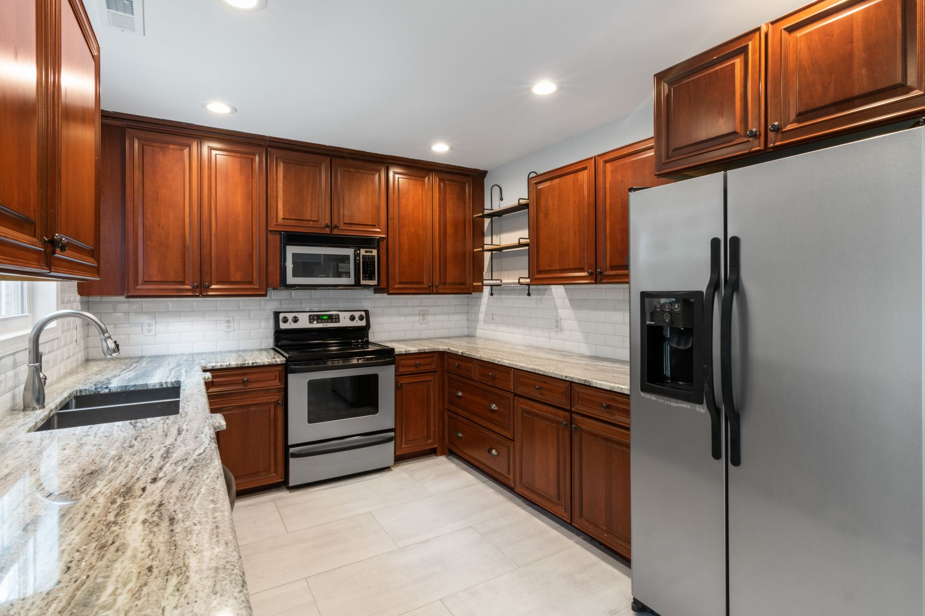 Elegant kitchen interior featuring wooden cabinetry and stainless steel appliances in Bellevue, WA