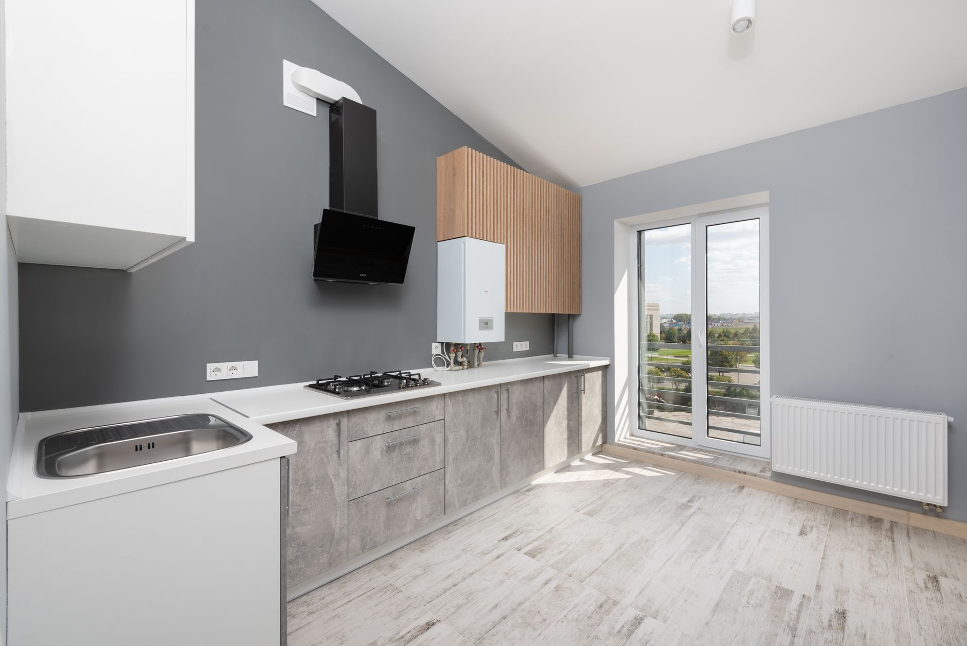 Sleek and modern kitchen with minimalist design, light colors, and large windows in Bellevue, WA